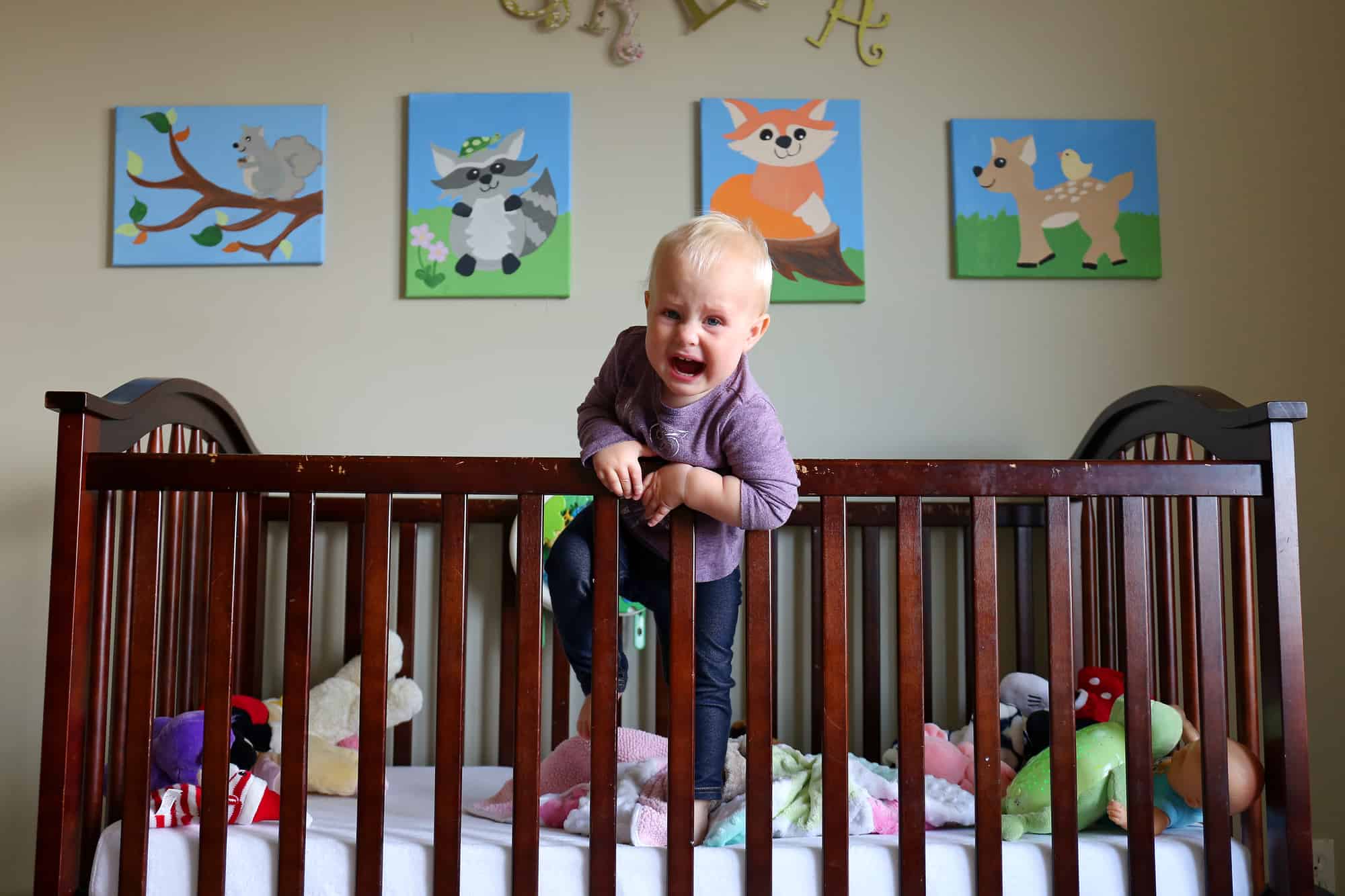 toddler-trying-to-get-out-of-the-crib